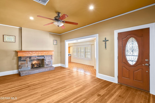 3020 Wheeling Ave, El Paso, TX 79930 - foyer entrance featuring baseboards, wood finished floors, ceiling fan, a stone fireplace, and crown molding
