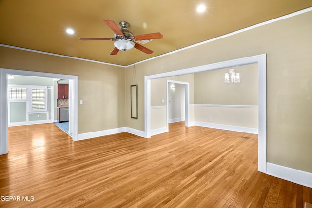 3020 Wheeling Ave, El Paso, TX 79930 - spare room with ceiling fan, baseboards, light wood-style flooring, a chandelier, and crown molding