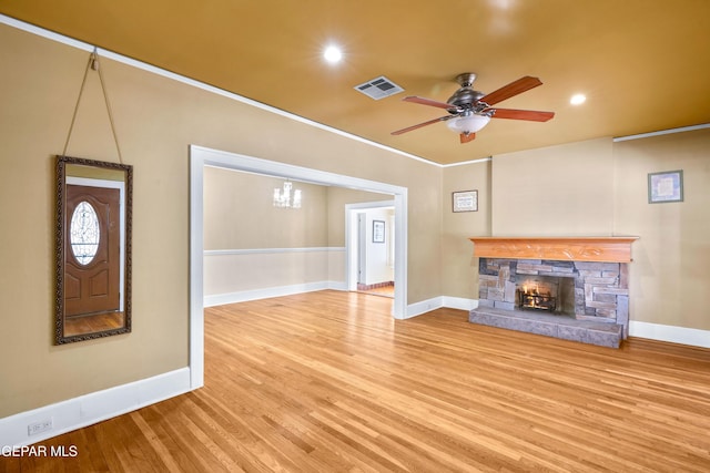 3020 Wheeling Ave, El Paso, TX 79930 - unfurnished living room featuring a stone fireplace, wood finished floors, a ceiling fan, baseboards, and recessed lighting