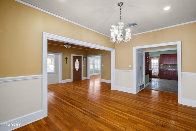 3020 Wheeling Ave, El Paso, TX 79930 - unfurnished dining area featuring ornamental molding, a chandelier, wood finished floors, baseboards, and ceiling fan