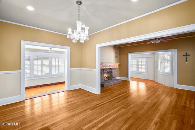 3020 Wheeling Ave, El Paso, TX 79930 - unfurnished living room with a chandelier, wood finished floors, ornamental molding, a fireplace, and baseboards