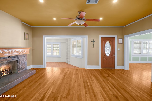 3020 Wheeling Ave, El Paso, TX 79930 - foyer featuring light wood-type flooring, baseboards, crown molding, a fireplace, and ceiling fan