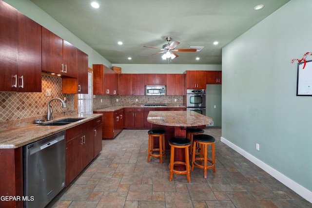 3020 Wheeling Ave, El Paso, TX 79930 - kitchen featuring appliances with stainless steel finishes, a sink, decorative backsplash, baseboards, and recessed lighting