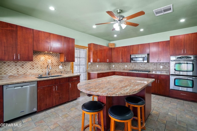 3020 Wheeling Ave, El Paso, TX 79930 - kitchen featuring stainless steel appliances, a sink, stone finish flooring, a ceiling fan, and recessed lighting