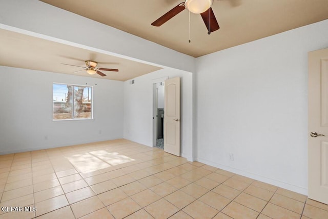 unfurnished room with a ceiling fan and light tile patterned flooring