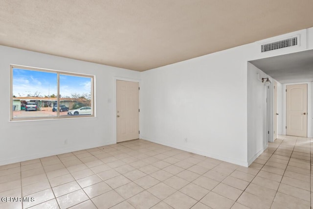 spare room featuring baseboards