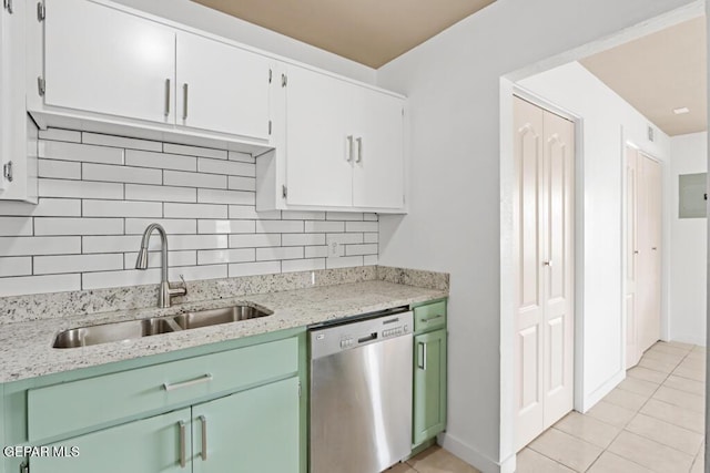 kitchen featuring dishwasher, a sink, backsplash, and light tile patterned floors