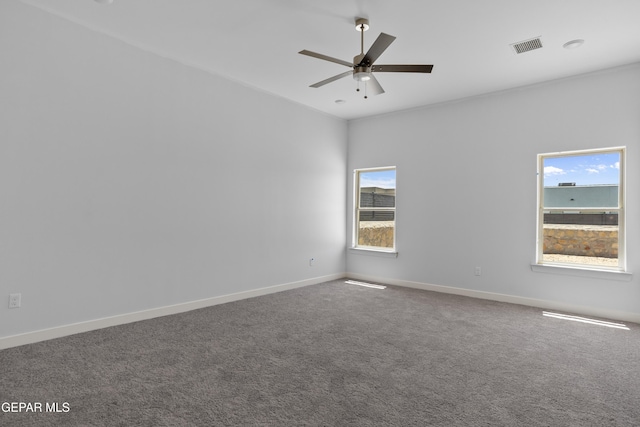 unfurnished room with carpet, a ceiling fan, plenty of natural light, and visible vents
