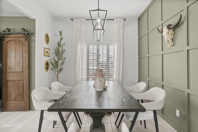13352 Eton Ct, El Paso, TX 79928 - dining room with light wood-style flooring and a barn door