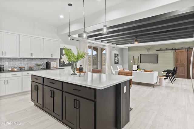 13352 Eton Ct, El Paso, TX 79928 - kitchen featuring white cabinets, tasteful backsplash, beamed ceiling, light wood-style floors, and pendant lighting