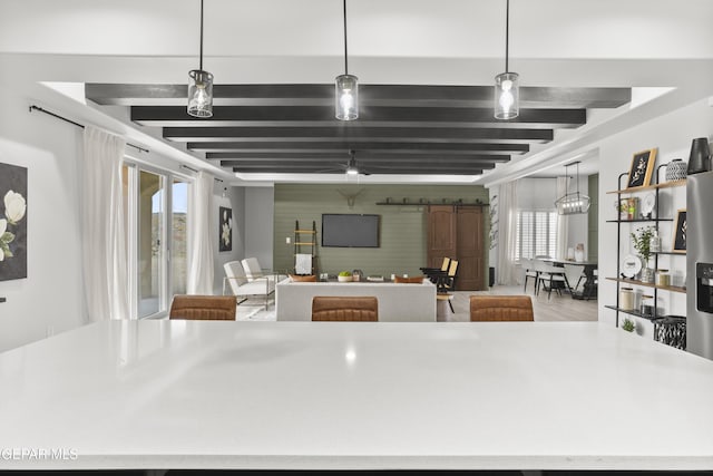 13352 Eton Ct, El Paso, TX 79928 - kitchen featuring healthy amount of natural light, beamed ceiling, an accent wall, pendant lighting, and wood finished floors