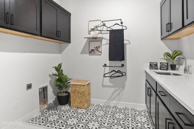 13352 Eton Ct, El Paso, TX 79928 - laundry area featuring cabinet space, baseboards, hookup for an electric dryer, and tile patterned flooring