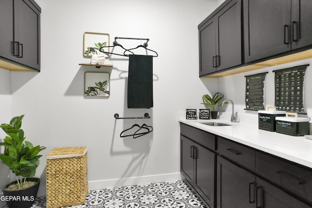 13352 Eton Ct, El Paso, TX 79928 - washroom featuring a sink, baseboards, and light tile patterned floors