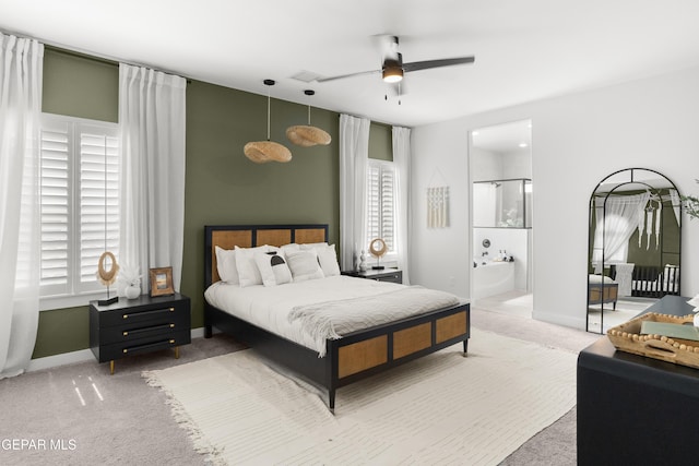 13352 Eton Ct, El Paso, TX 79928 - carpeted bedroom with multiple windows, ensuite bath, and baseboards