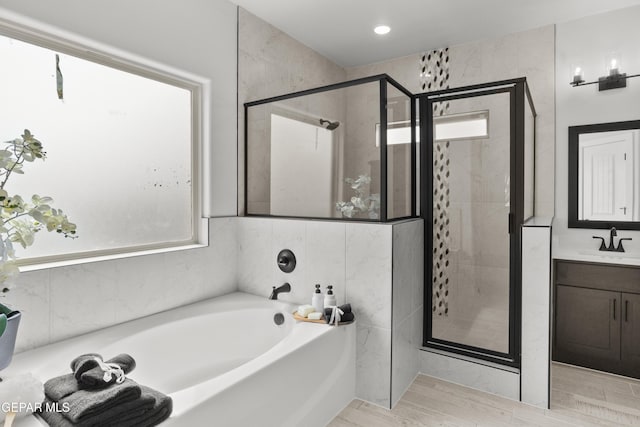 13352 Eton Ct, El Paso, TX 79928 - bathroom featuring a bath, a stall shower, vanity, and wood finished floors