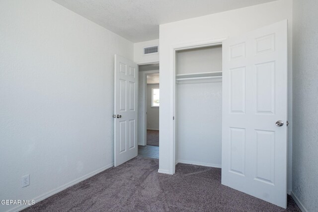 420 Kelvin Ave, El Paso, TX 79915 - unfurnished bedroom featuring dark colored carpet, a closet, and baseboards