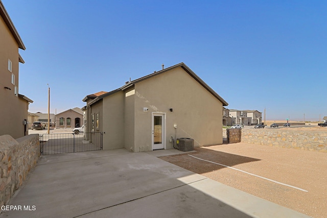 14296 Chris Zingo Ln, El Paso, TX 79928 - back of property featuring a gate, a residential view, stucco siding, fence, and a patio area