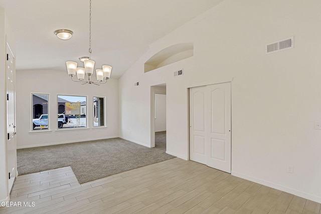 14296 Chris Zingo Ln, El Paso, TX 79928 - interior space with light wood-type flooring, a chandelier, lofted ceiling, and visible vents