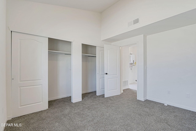 14296 Chris Zingo Ln, El Paso, TX 79928 - unfurnished bedroom with carpet flooring, visible vents, baseboards, and multiple closets