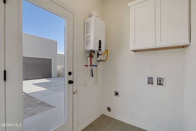 14296 Chris Zingo Ln, El Paso, TX 79928 - clothes washing area featuring tankless water heater, baseboards, washer hookup, cabinet space, and electric dryer hookup