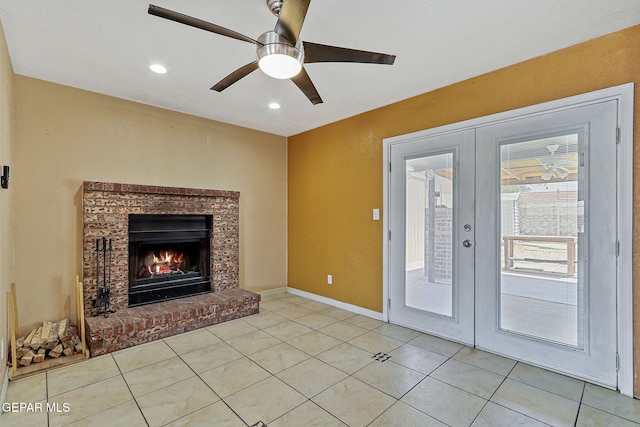unfurnished living room with french doors, ceiling fan, recessed lighting, baseboards, and a brick fireplace