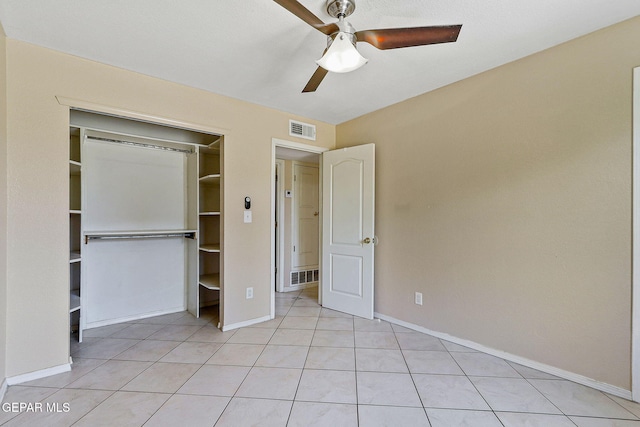 unfurnished bedroom featuring baseboards, light tile patterned floors, a closet, and a ceiling fan