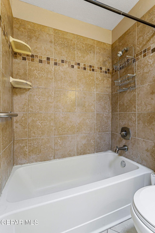 full bathroom with toilet and washtub / shower combination