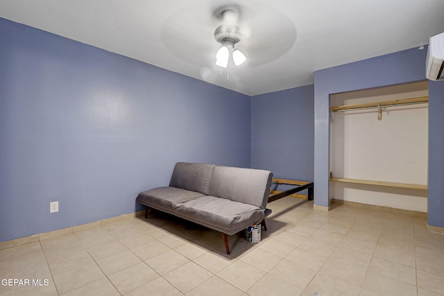 living area with ceiling fan, light tile patterned flooring, and baseboards
