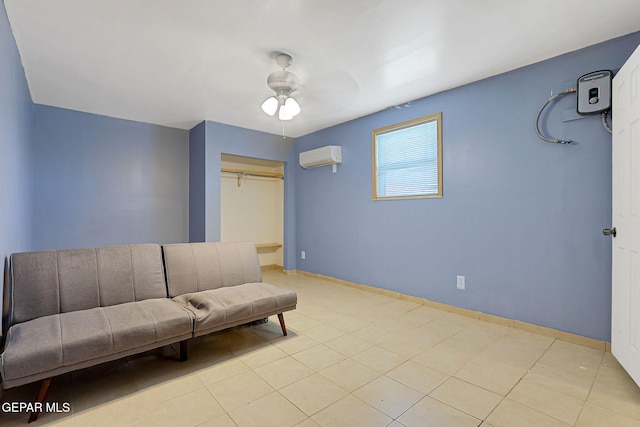 living area with a ceiling fan, a wall mounted air conditioner, and baseboards