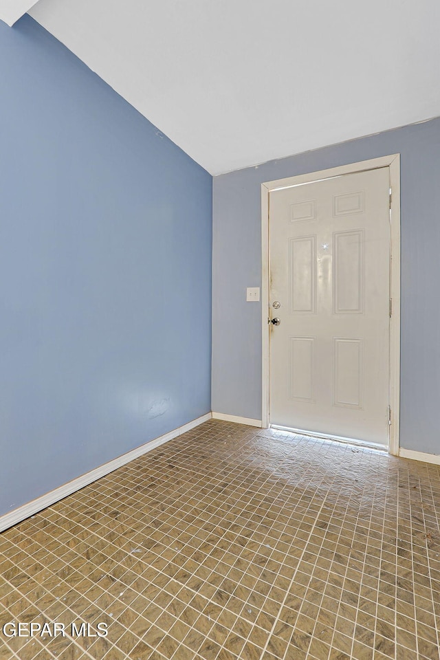 unfurnished room with baseboards