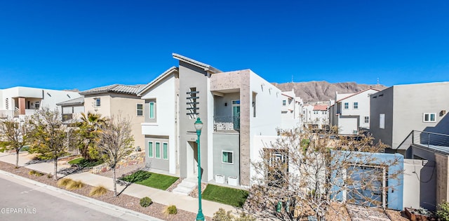 view of front of house with a residential view and stucco siding
