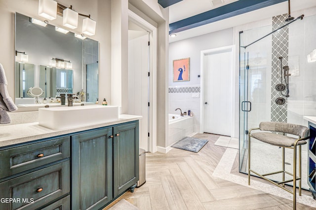 bathroom with a shower stall, a garden tub, and vanity