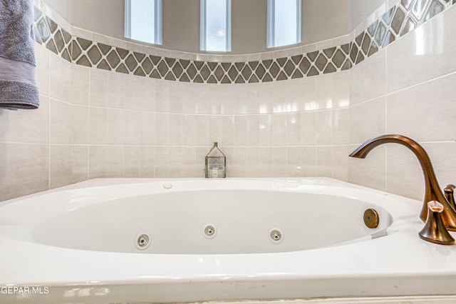 bathroom featuring a tub with jets