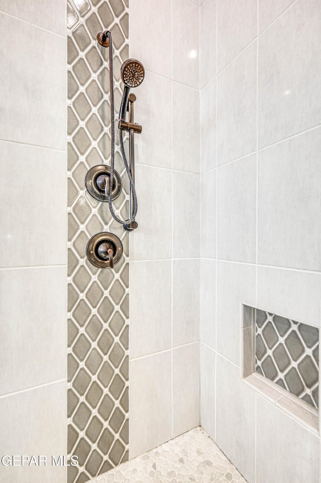 bathroom with tiled shower