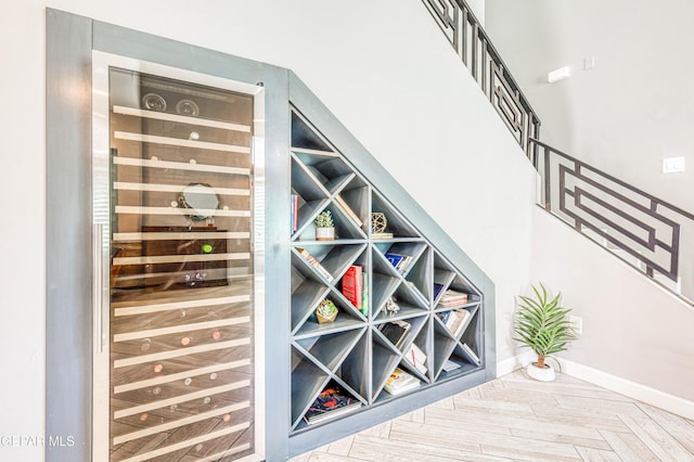 wine cellar with beverage cooler and baseboards