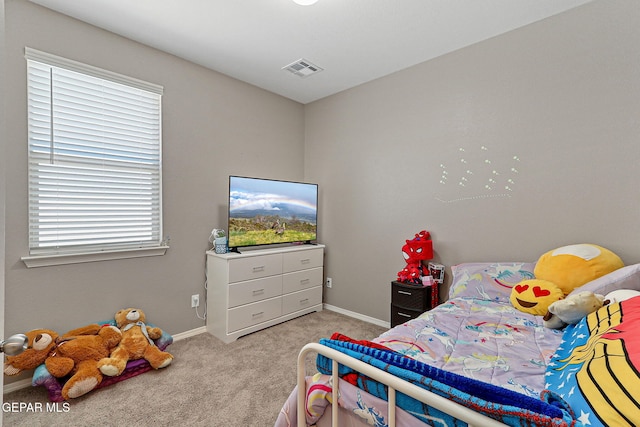 carpeted bedroom with baseboards and visible vents