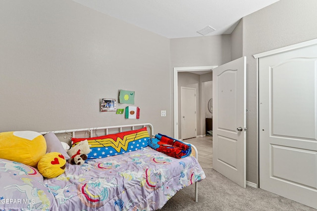 bedroom featuring light carpet and visible vents