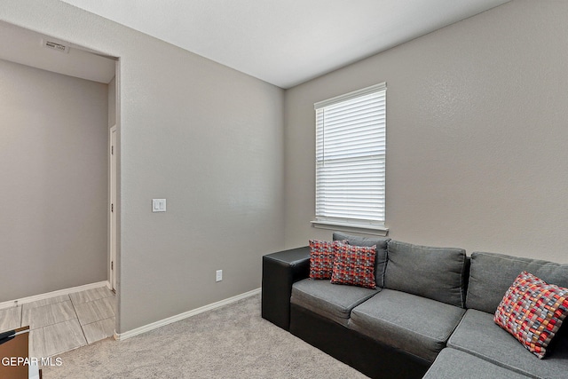 carpeted living room featuring baseboards and visible vents