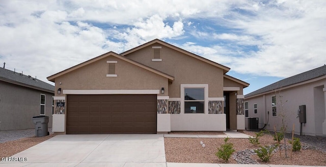 14920 Tierra Fortaleza Ave, El Paso, TX 79938 - view of front facade featuring concrete driveway, an attached garage, stucco siding, and central AC