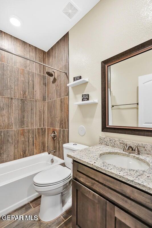 14920 Tierra Fortaleza Ave, El Paso, TX 79938 - full bathroom featuring toilet, bathing tub / shower combination, vanity, and visible vents