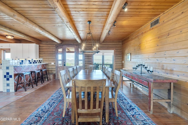 2 Scenic Ridge Rd N, Alpine, TX 99999 - dining space with hardwood / wood-style floors, wooden ceiling, beamed ceiling, rustic walls, and a chandelier