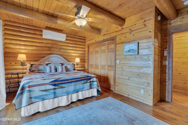 2 Scenic Ridge Rd N, Alpine, TX 99999 - bedroom with wood ceiling, a wall mounted AC, beam ceiling, hardwood / wood-style flooring, and log walls