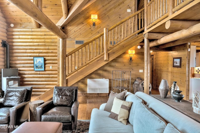 2 Scenic Ridge Rd N, Alpine, TX 99999 - living area featuring rustic walls, high vaulted ceiling, beam ceiling, a wood stove, and stairs