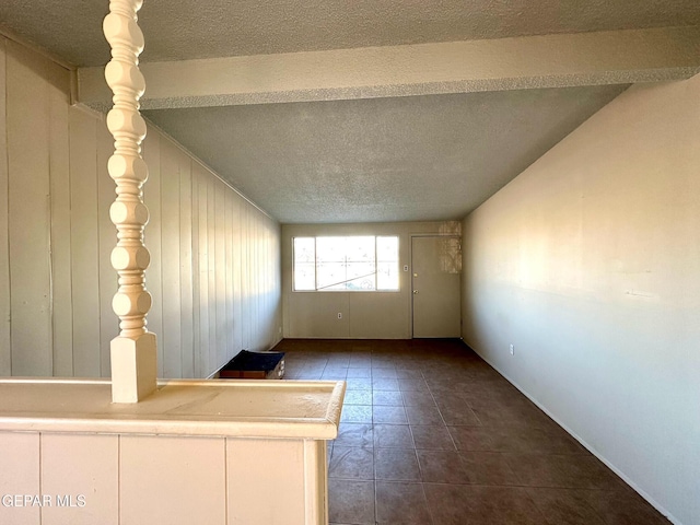 45 S Boone St, El Paso, TX 79905 - tiled empty room featuring a textured ceiling and lofted ceiling with beams
