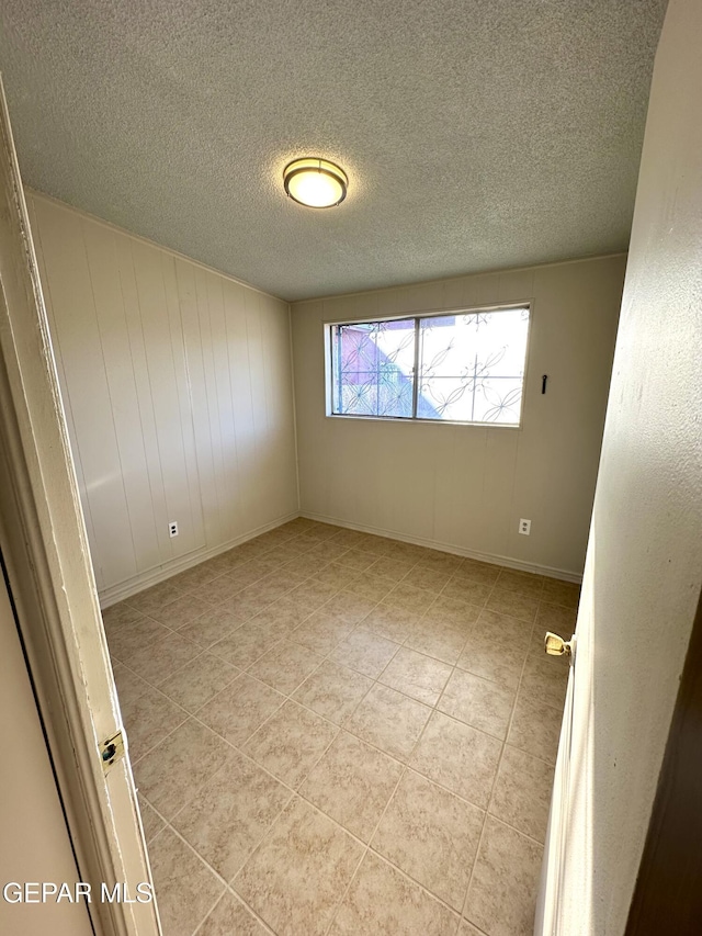 45 S Boone St, El Paso, TX 79905 - spare room with a textured ceiling and light tile patterned floors