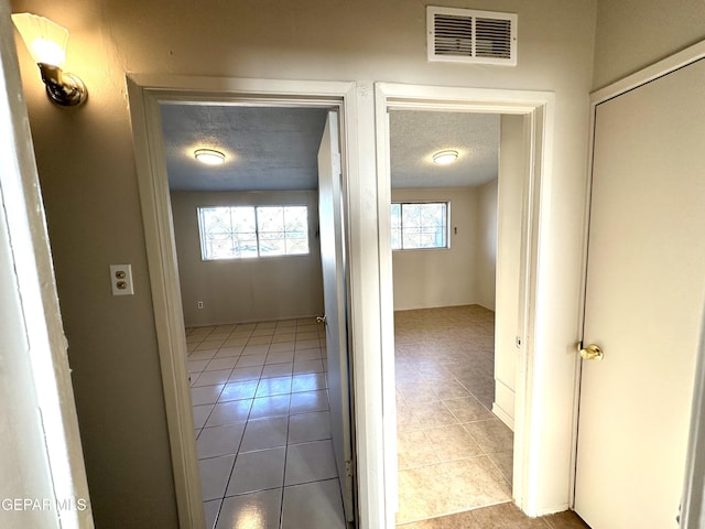 45 S Boone St, El Paso, TX 79905 - hallway with tile patterned floors, a textured ceiling, and visible vents