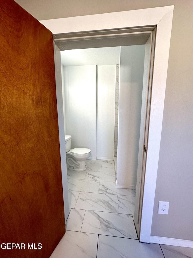 45 S Boone St, El Paso, TX 79905 - bathroom featuring toilet, marble finish floor, and baseboards