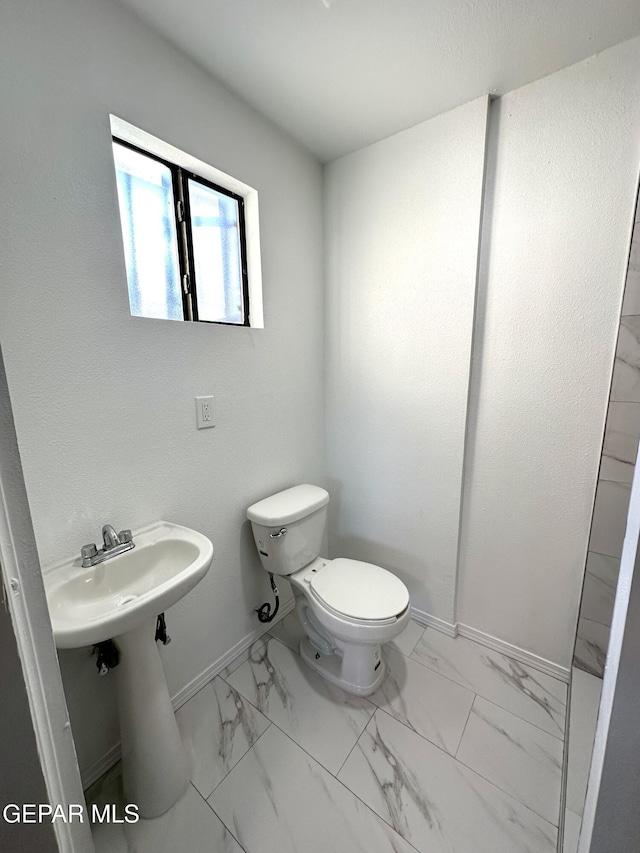 45 S Boone St, El Paso, TX 79905 - bathroom featuring toilet, marble finish floor, and baseboards