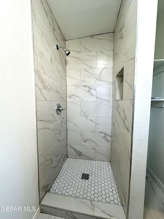 45 S Boone St, El Paso, TX 79905 - full bathroom featuring a stall shower, baseboards, and marble finish floor