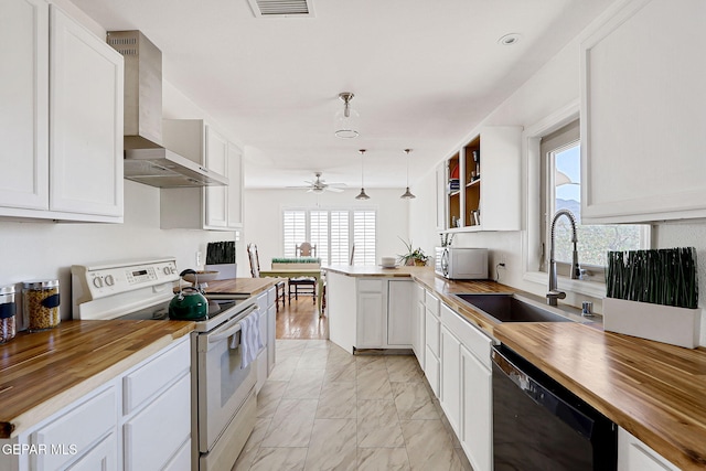 4731 Leeds Ave, El Paso, TX 79903 - kitchen with a sink, wall chimney range hood, electric range, butcher block countertops, and dishwasher